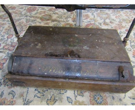 A vintage carpet sweeper