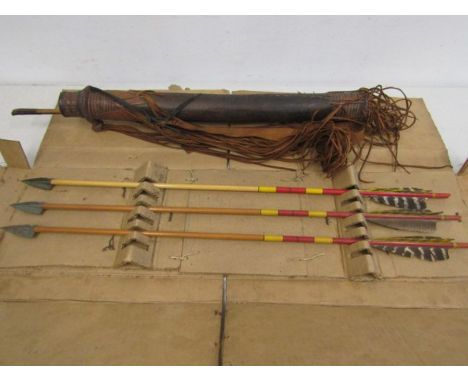 Vintage arrows with metal heads and a tribal arrow holder with arrows