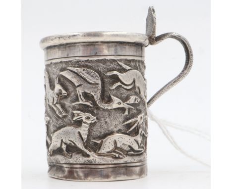 19th century Raj period Indian silver tankard, the body having designs of sprinting indigenous animals in relief, the handle 