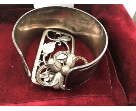 Three Georg Jensen silver items: a bangle and two brooches