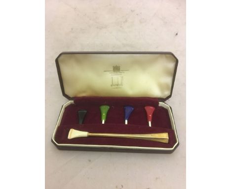 A gold Dunhill cigarette holder in fitted case with various coloured mouth pieces