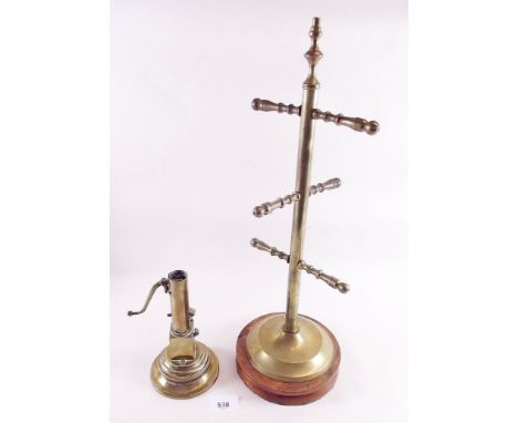 A brass model table lighter in form of water pump and a brass cup stand 