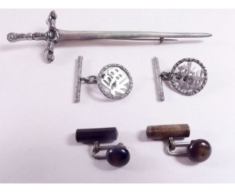 A silver dagger form cloak pin and two pairs of cufflinks 