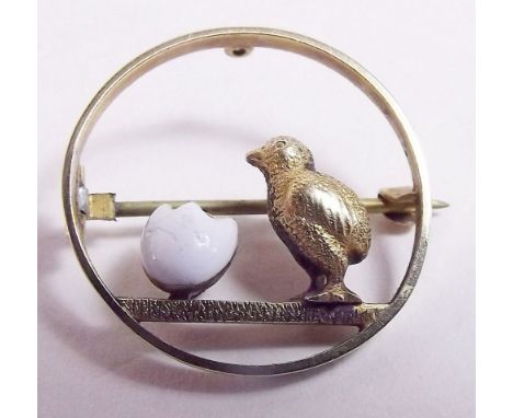 An Edwardian 15 carat gold and enamel chick and egg brooch 