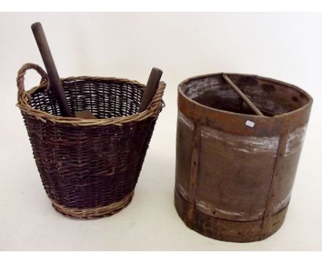 A wooden and metal bound bucket and a basket of tools