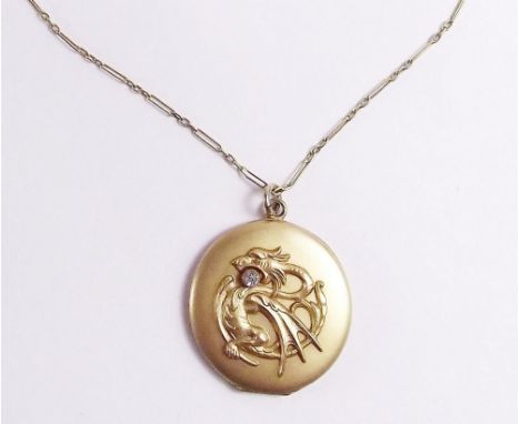 A circular locket decorated Chinese dragon on 9 carat gold chain 