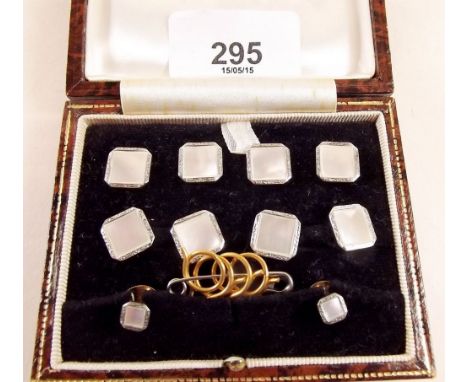 A gentlemans 9 carat white gold and mother of pearl dress stud set comprising a pair of cufflinks, four buttons and two studs