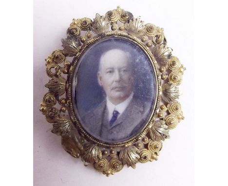 A miniature portrait of a man in 15 carat gold oval foliage frame