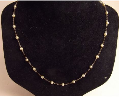 A 9 carat gold chain interspersed small pearls