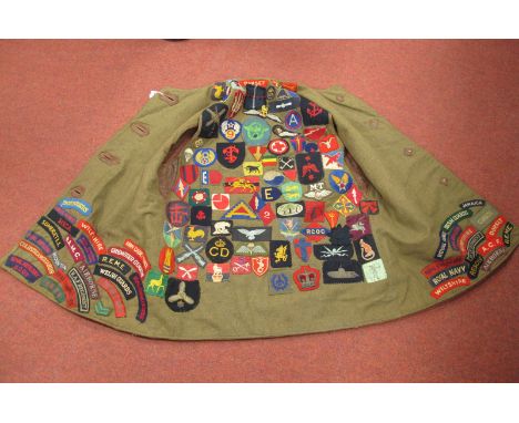 A WWII British Army Leather Jerkin, with Military cloth patches sewn on to interior patches include Regimental and Divisional