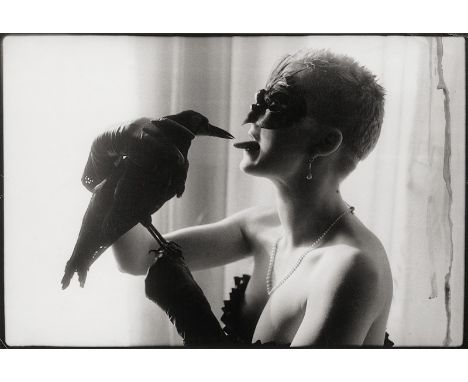 Marquardt, Sven -- Masked woman with crow. 1985. Vintage gelatin silver print. 27,2 x 39,6 cm. Signed by the photographer in 