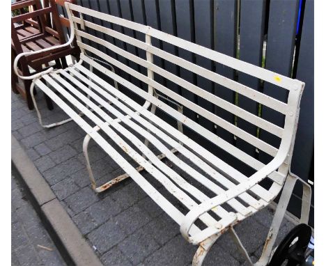 A 19th century slatted wrought iron four-seater garden bench, raised on pronounced strapwork supports, width 183cm