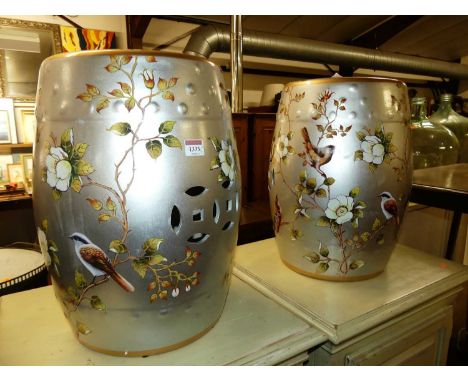 A pair of silvered and polychrome painted ceramic barrel garden seats, h.45cm