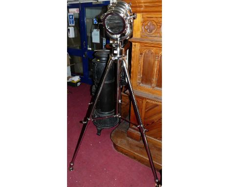 A contemporary polished chromed metal freestanding floor light, in the form of a nautical light, raised on adjustable tripod 