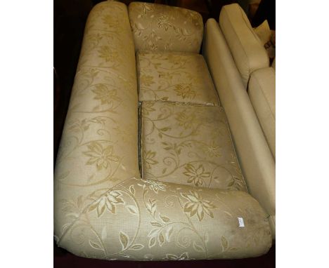 A late Victorian cream floral upholstered three seater drop end sofa, having scroll arms and raised on squat turned cabriole 