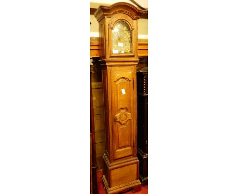 An antique French joined oak longcase clock, 19th century and later, having an arched brass dial (arch probably associated), 