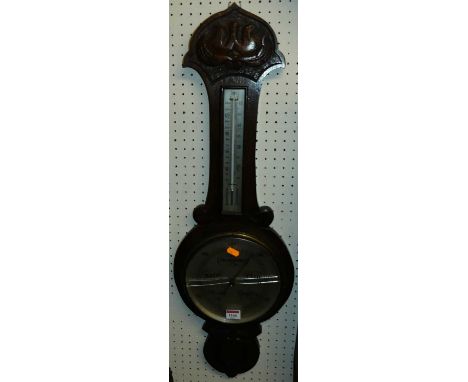 A carved oak two-dial aneroid wheel barometer, h.82cm (glass a/f)