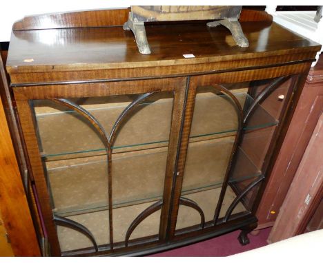 A 1930s mahogany ledgeback bow front double door glazed china display cabinet, width 102cm