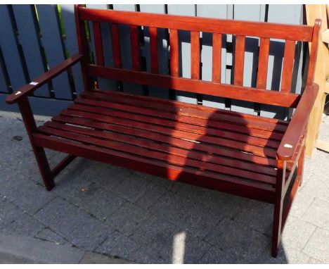 A stained wood and slatted two-seater garden bench, width 122cm