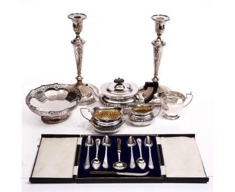 A PAIR OF SILVER PLATED CANDLESTICKS of lobed and gadrooned form; a plated half lobed three piece tea service; a pierce decor