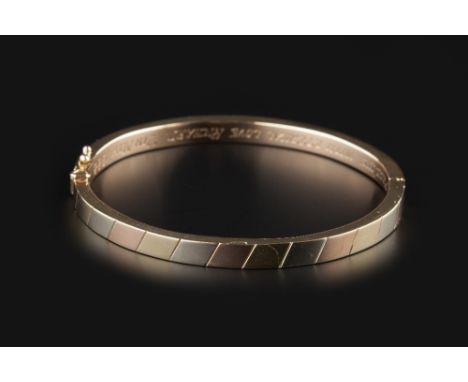 A COLLECTION OF BANGLES AND BRACELETS, comprising a 9ct three colour gold oval hinged bangle, inscribed to interior, two furt