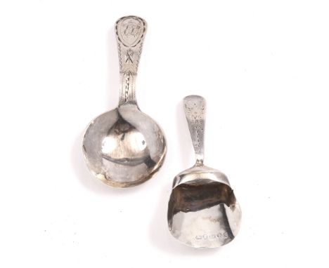 A GEORGE III SILVER CADDY SPOON of shovel form, 8cm long by John Lawrence & Co, Birmingham 1817; and another with engraved ha