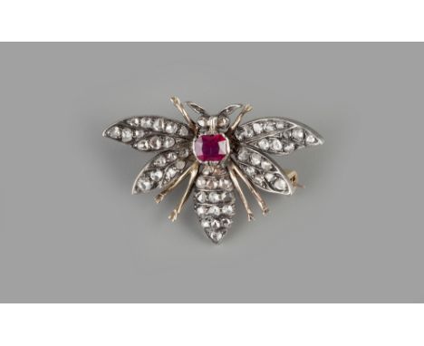 A RUBY AND DIAMOND SET INSECT BROOCH,  naturalistically modelled with outstretched wings of lasque-cut diamonds, to a similar