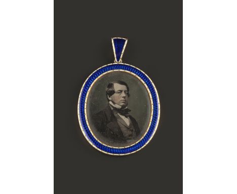 A 19TH CENTURY ENAMEL LOCKET PENDANT,  the oval glazed gold locket framed by a beaded white and blue enamel border, length 5.