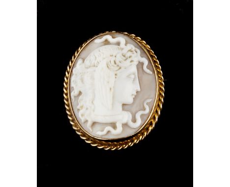 THREE CAMEO BROOCHES, comprising an oval shell cameo brooch, carved to depict Medusa in profile, to a ropetwist decorated mou