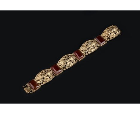 THREE BRACELETS,  comprising a panel bracelet, pierced and engraved with peacocks, flowerheads and foliage, a bi-colour bangl