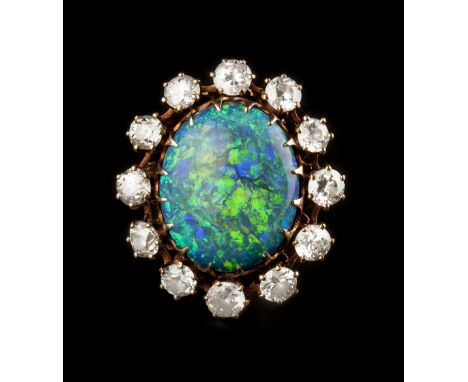 AN OPAL AND DIAMOND CLUSTER RING, the oval cabochon opal claw set within a surround of brilliant and old brilliant-cut diamon