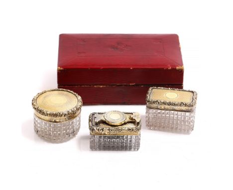 A SILVER GILT AND HOBNAIL CUT GLASS WRITING SET consisting of an inkwell and two pots in embossed decoration and in a red lea