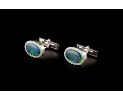 A PAIR OF BLACK OPAL AND DIAMOND CUFFLINKS, each oval cabochon black opal millegrain set within a single-cut diamond border, 