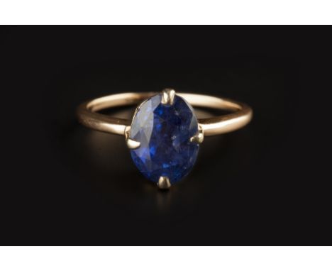 FOUR GEM SET DRESS RINGS,  comprising a sapphire single stone ring, the oval mixed-cut sapphire in four claw setting, yellow 