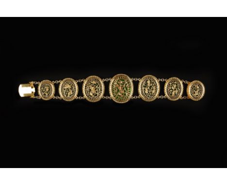 A 19TH CENTURY INDIAN PERTABGHAR ENAMEL BRACELET, circa 1865, the graduated oval panels pierced and engraved with animals, bi