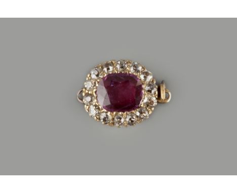 A RUBY AND DIAMOND CLASP, of cluster design, the oval mixed-cut ruby framed by old and single-cut diamonds, total diamond wei