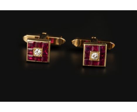 A PAIR OF RUBY AND DIAMOND CUFFLINKS, each square panel centred with a round brilliant-cut diamond, to a channel set border o