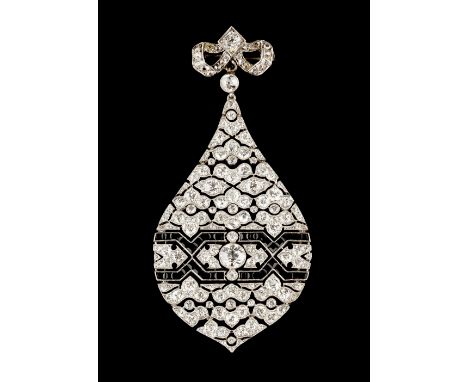 AN ART DECO DIAMOND AND ONYX PENDANT/BROOCH,   circa 1915-1925, the teardrop-shaped panel of articulated openwork form, mille