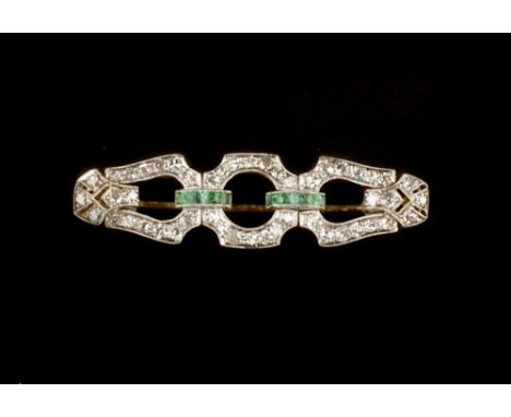 AN EMERALD AND DIAMOND PANEL BROOCH,  of tapered geometric openwork form, millegrain set with channels of rectangular step-cu