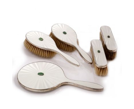 A SILVER AND ENAMEL FIVE PIECE DRESSING TABLE SET, the cream guilloche enamel backs centred with carved green jade plaques, c