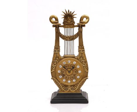 A FRENCH GILT METAL LYRE CLOCK with embossed ornament and ceramic numerals, battery movement, 35cm high