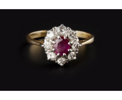 A RUBY AND DIAMOND CLUSTER RING, the oval mixed-cut ruby claw set within a border of round brilliant and Swiss-cut diamonds, 