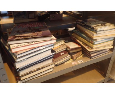 Shelf of books mainly car manuals by Haynes and WWII books