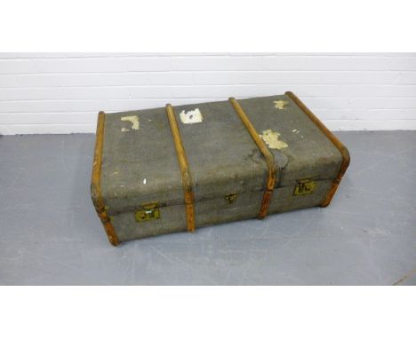 A vintage canvas bound travel trunk. 96 x 33cm