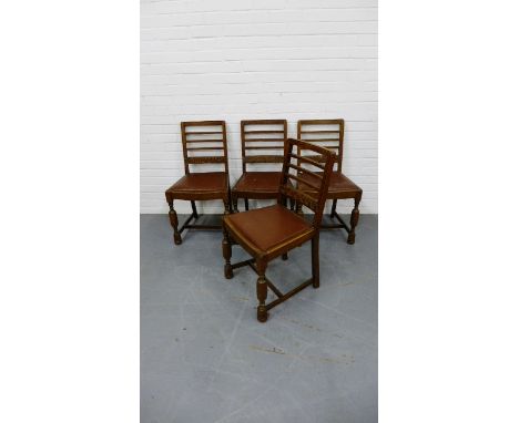 A set of four ladder back oak dining chairs.