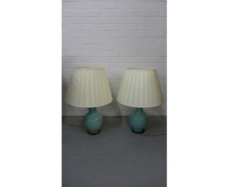 A pair of contemporary jade green glazed bottle neck table lamp bases, each on a circular wood effect base and complete with 