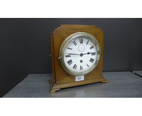 An Art Deco mahogany cased mantle clock, the circular enamel dial with Roman numerals and subsidiary seconds dial, 26 x 24cm 