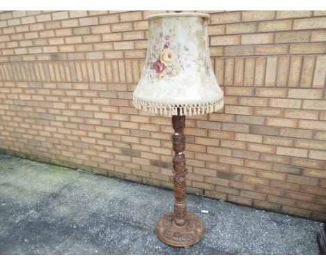 A heavily carved fruitwood standard lamp with shade, 156 cm n(high) - Est £20 - £40