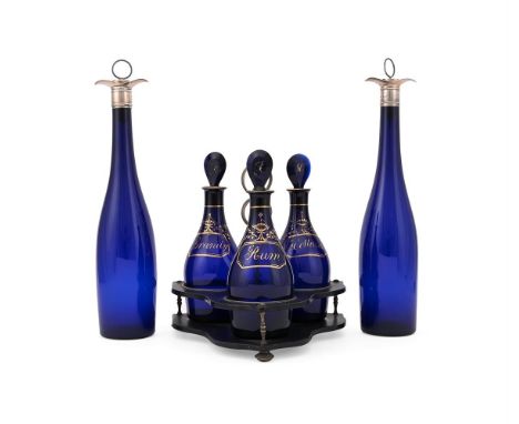 A SET OF THREE BRISTOL BLUE GLASS DECANTERS  19TH CENTURY  Gilt inscribed Rum, Holland and Brandy, initialled stoppers, in an