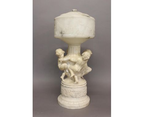 A LARGE ALABASTER AND MARBLE LAMP SIGNED L. SCHEGGI. The large lamp with a carved white marble base with a central column sur